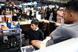 The milk-tooth tattooist: Nine-year-old Knight debuts at Thailand Tattoo Expo